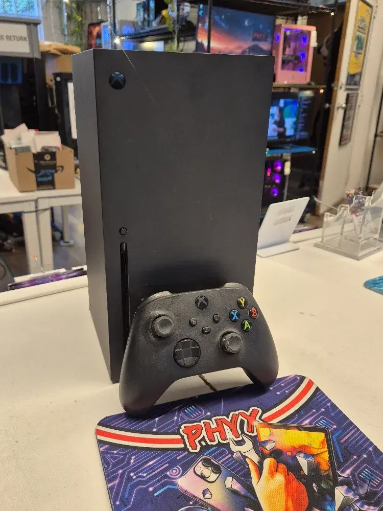 Microsoft Xbox Series X console in black with a controller, used condition, view 1 of 6