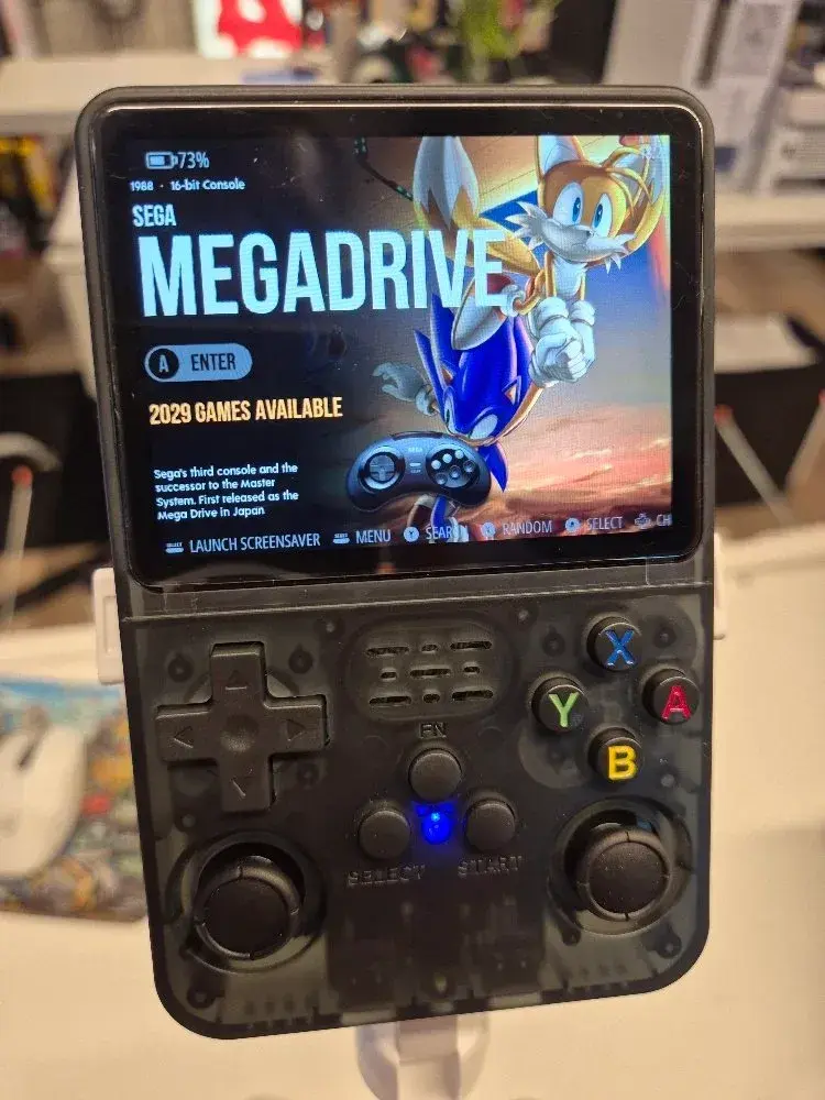 Black R36S from the front with the Sega Mega Drive menu on screen