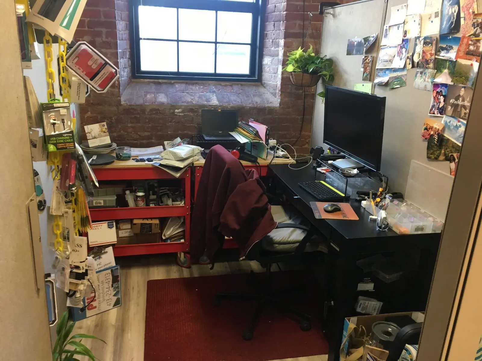 The first PHYX office — workbench, tools, and a hoodie over the chair
