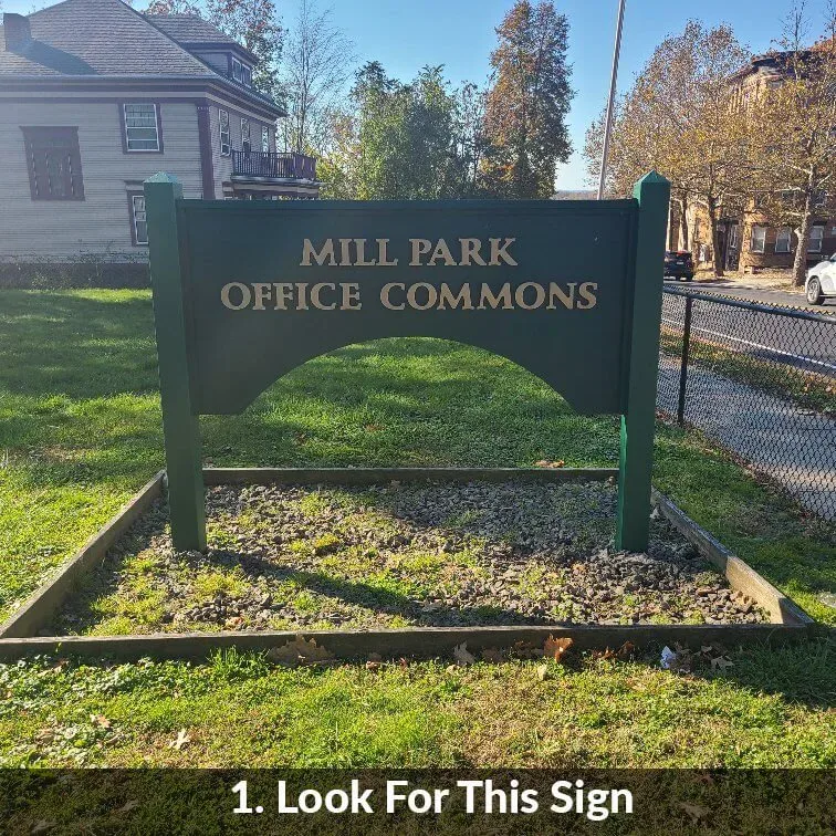Step 1 — look for this sign: the green Mill Park Office Commons sign from the street