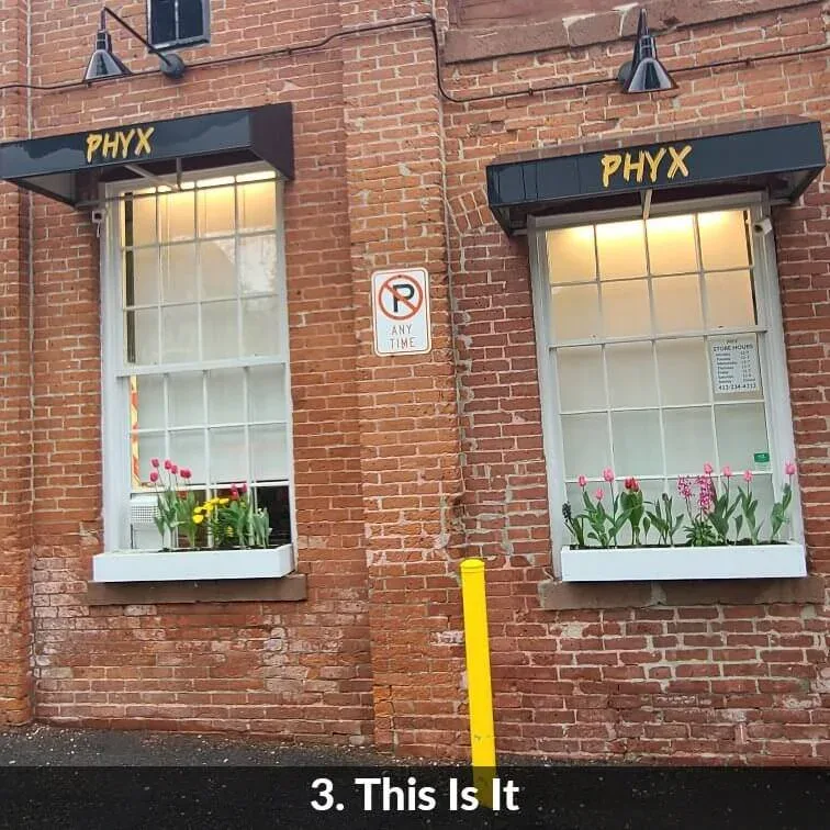 Step 3 — this is it: the PHYX windows on the brick face of Building 95